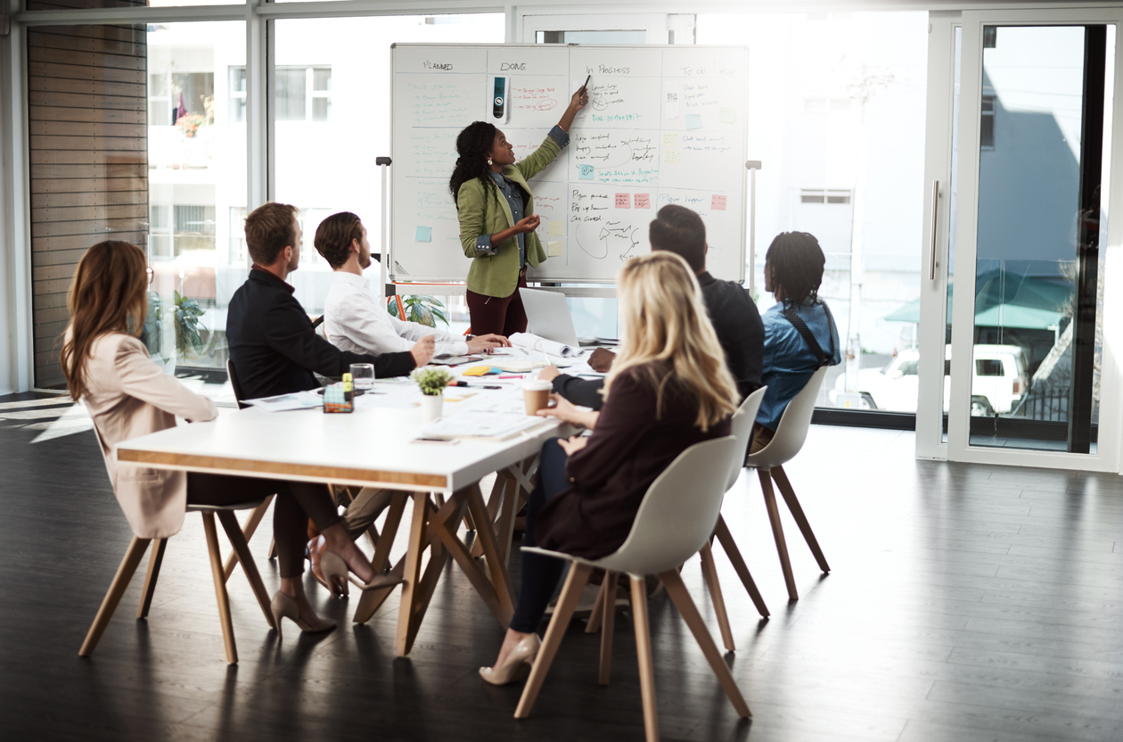 A Digital Marketing Manager Leads a Team Meeting in a Conference Room.