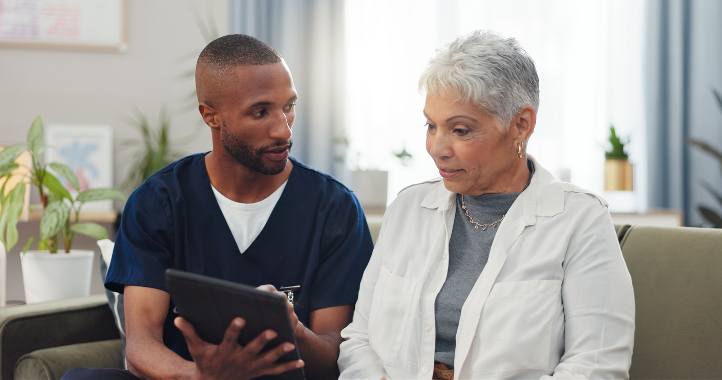 A nurse showing a patient information on a tablet.