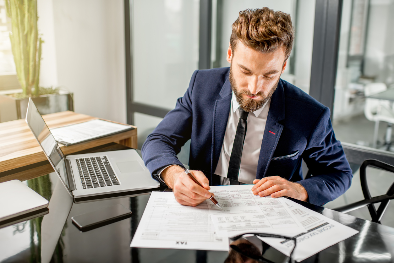 A real estate accountant works on a report in an office.