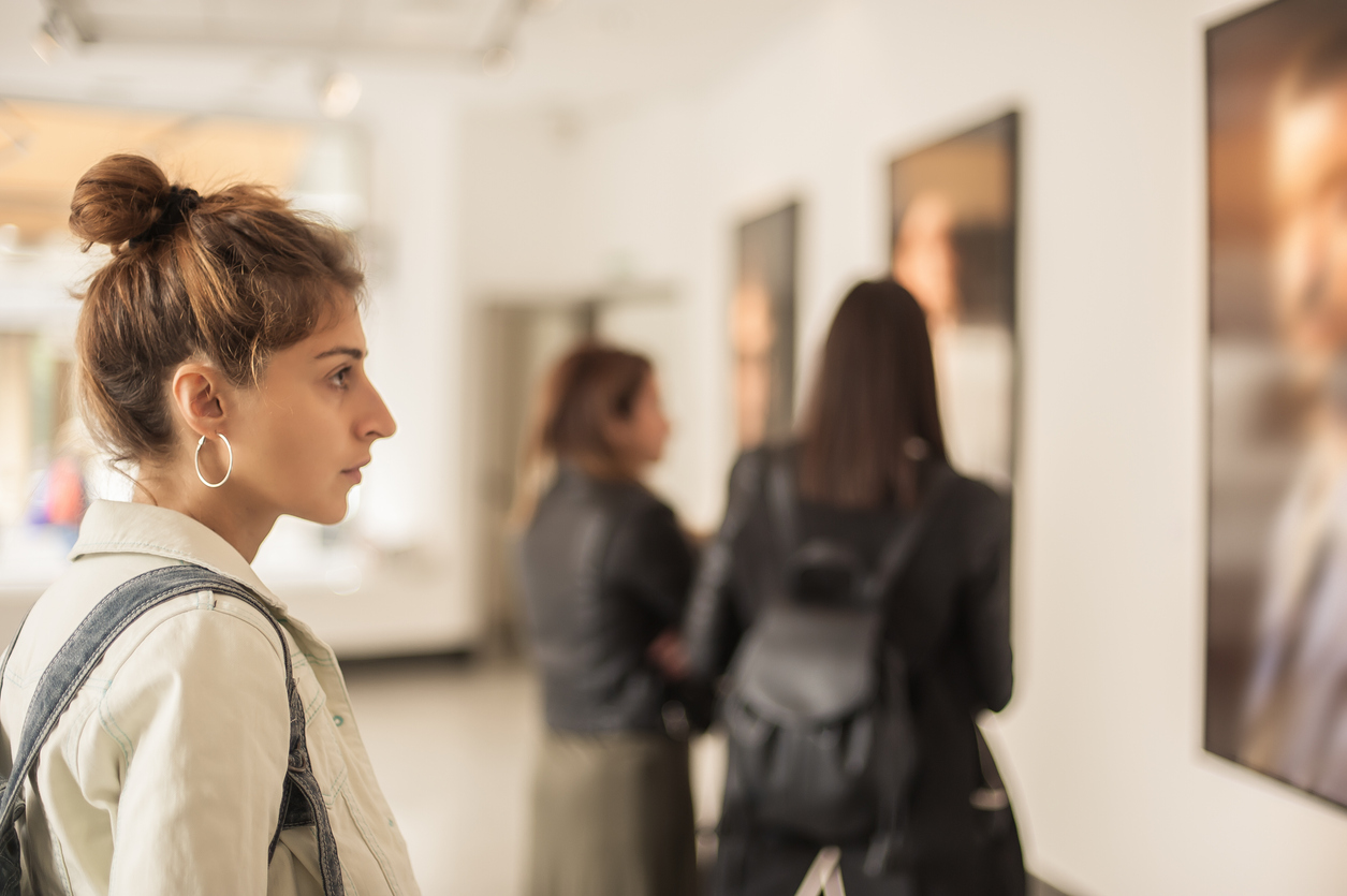 People View Paintings in a Museum.