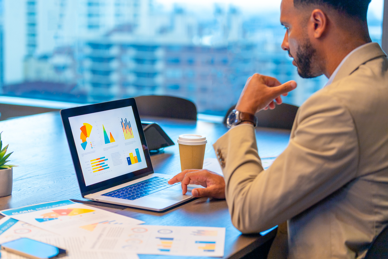 An HR professional reviews a data dashboard on a laptop