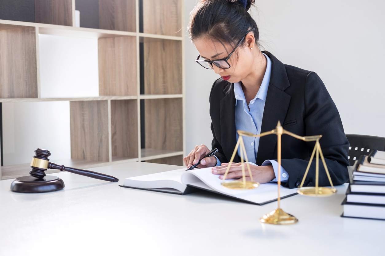 Criminal Justice Student Sitting at a Desk and Taking Notes.