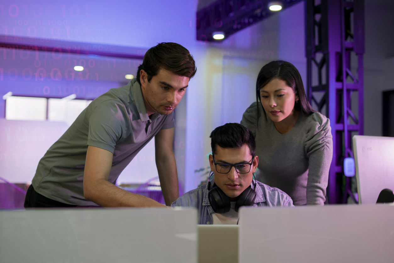 Homeland security professionals looking at computer monitors.