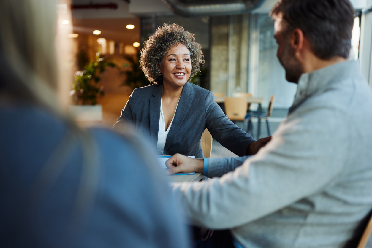 An investment banker meets with clients in an office.