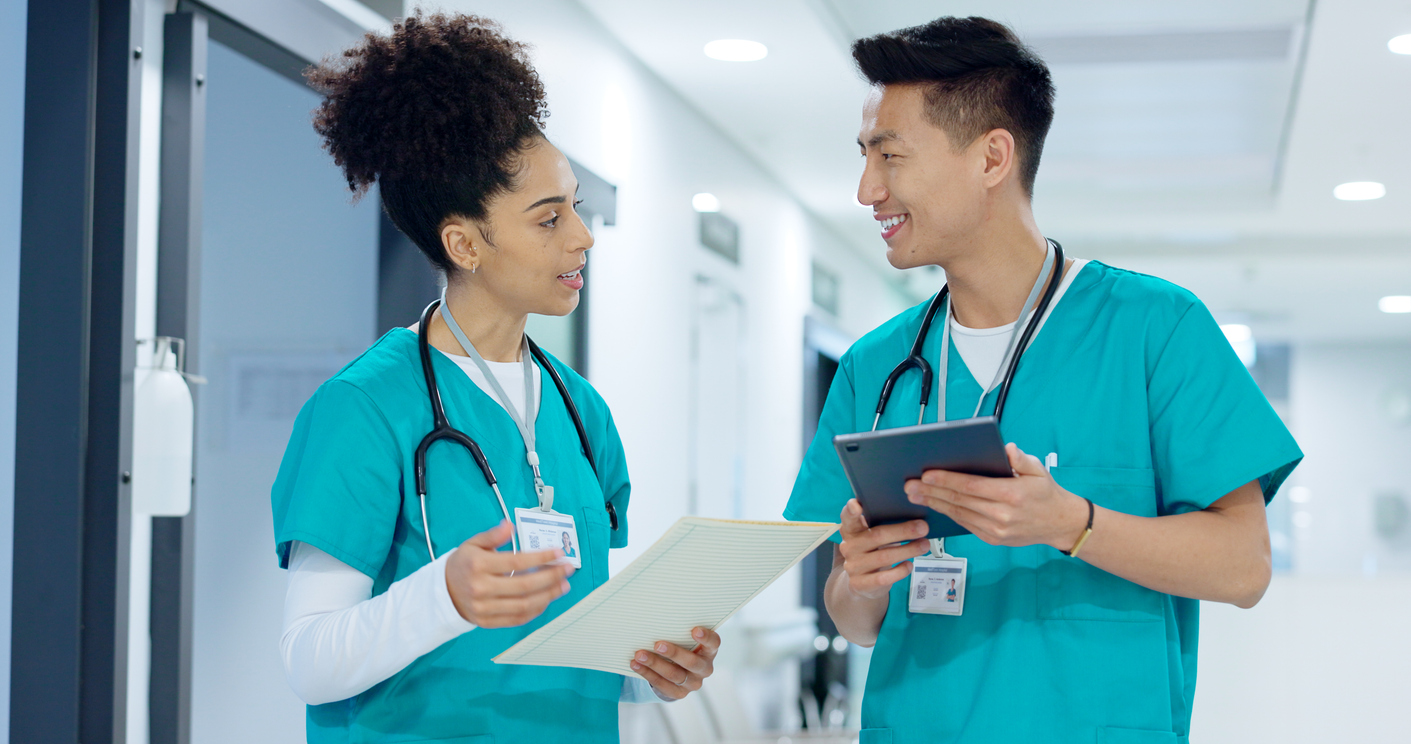 Nurses Talking in a Hallway of a Medical Facility.