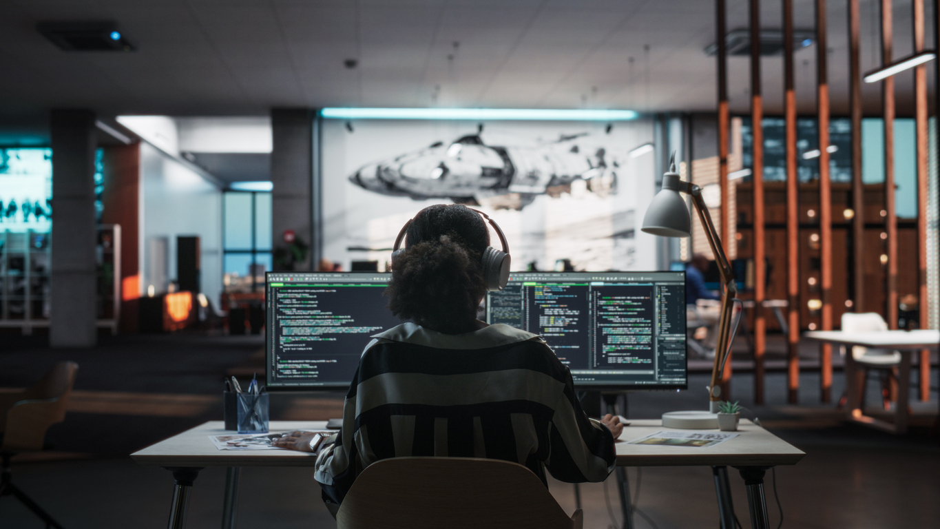 Cybersecurity Professional Working on Two Monitors.