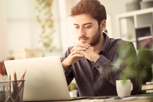 A criminal justice student works on their laptop.