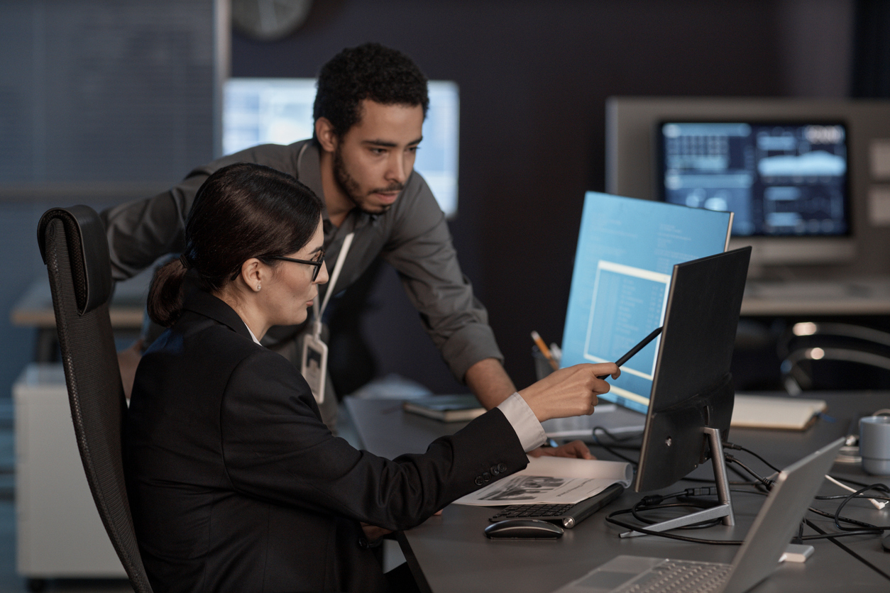 Two Analysts Working Together on Computer Monitors..jpg