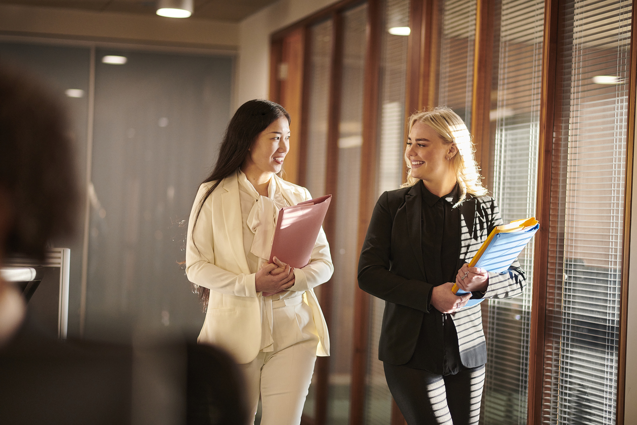 A Paralegal and an Attorney Walking in a Law Office.