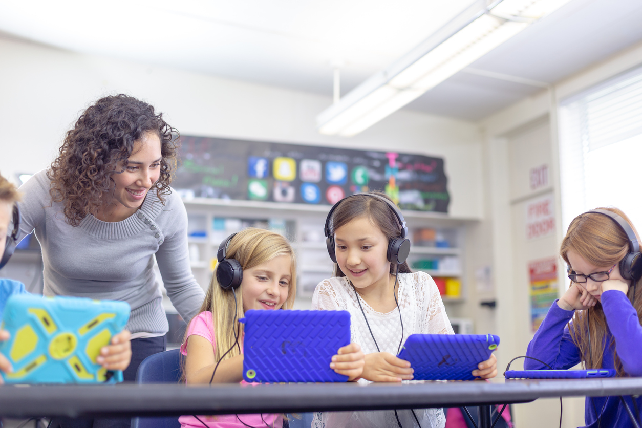 Students Wearing Headphones While Working on Tablets in a Classroom.