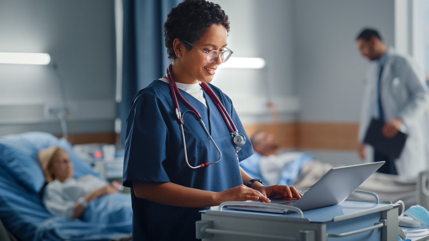 A nurse working with medical technology.