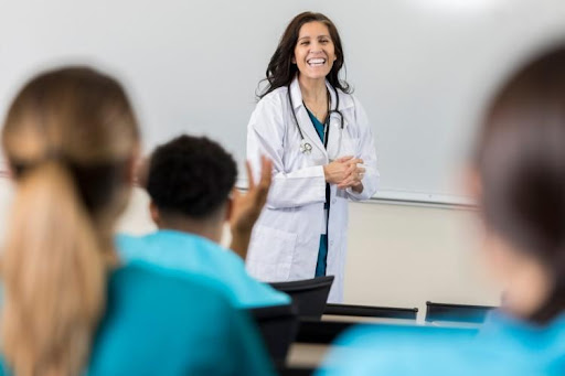A nurse educator standing in front of a class.