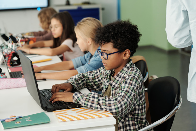 Students working on computers in a classroom.