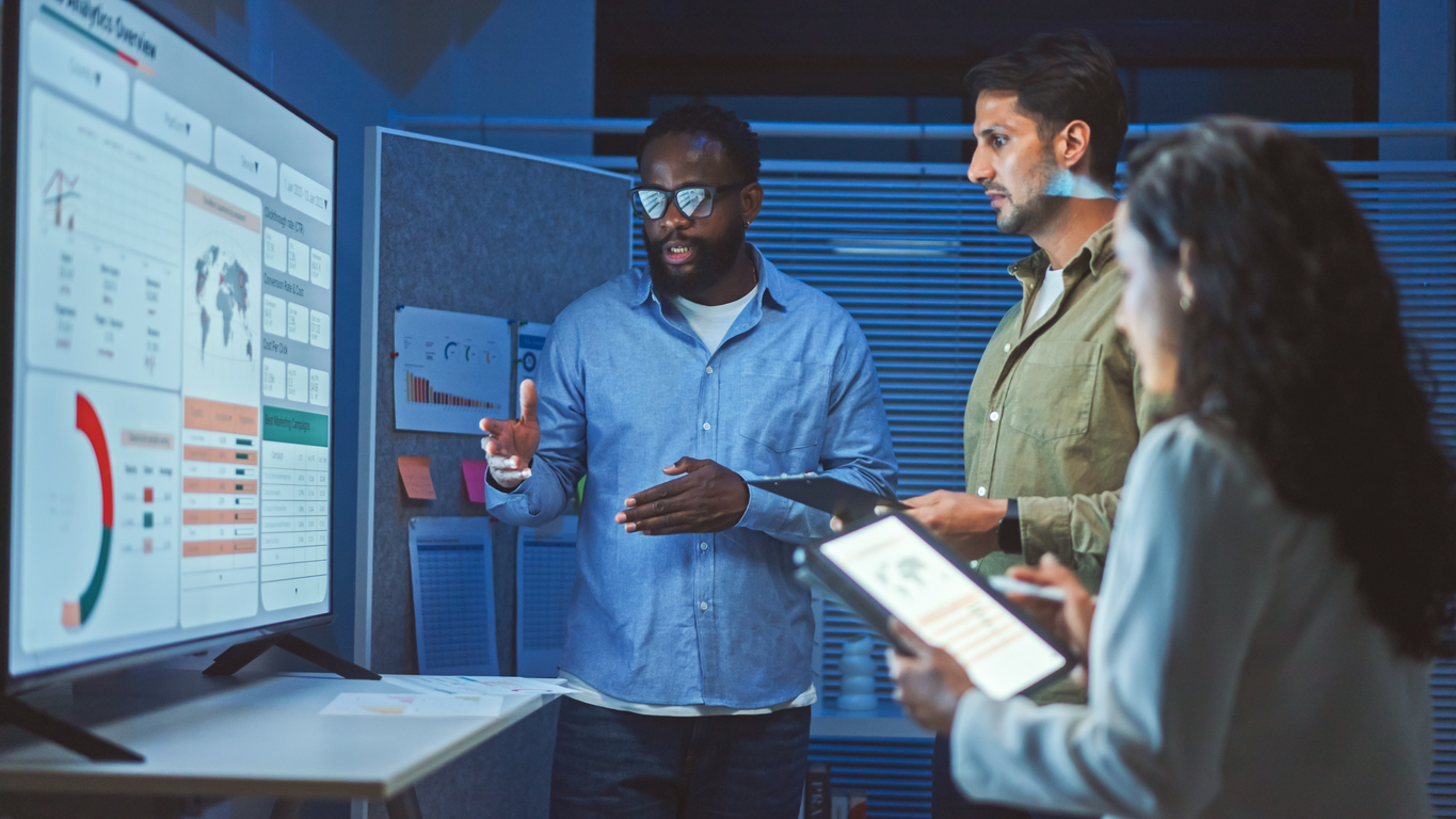 Information Technology Professionals Working Together on a Monitor.