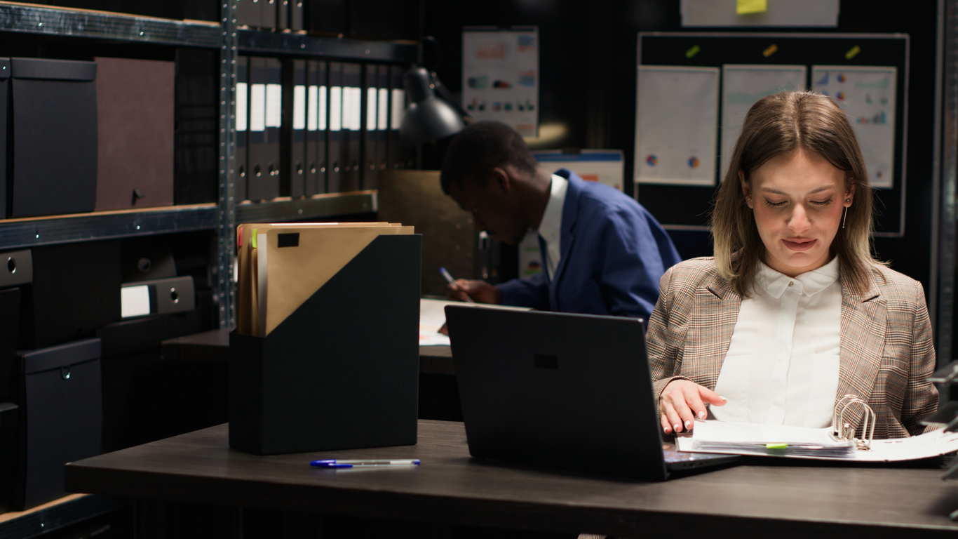 A Criminologist Reviews Evidence in an Investigation Room.