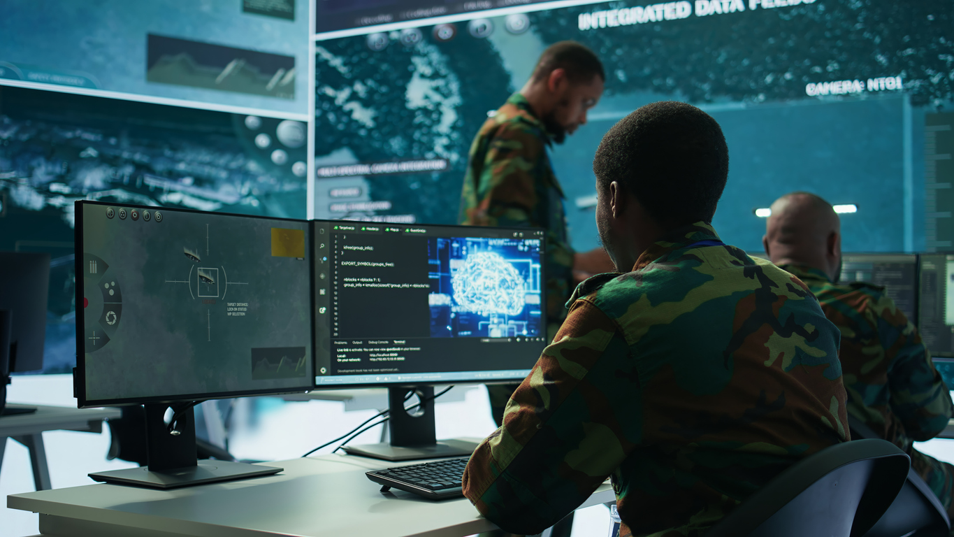 A Dia Intelligence Officer Working on Computer Monitors at a Desk..jpg