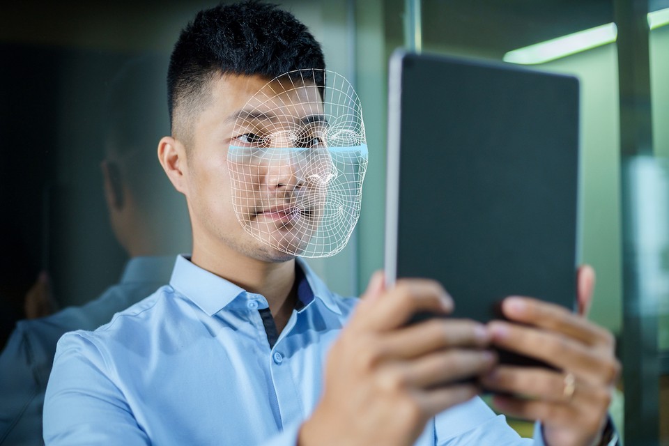 A man looks into a device with a facial recognition feature.