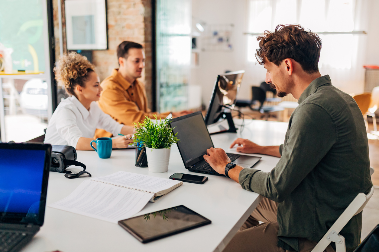 Small Business Professionals Sitting at a Desk and Working on Computers..jpg