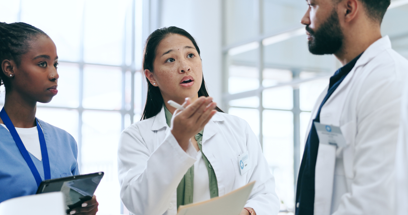 A nursing manager talking to two colleagues.