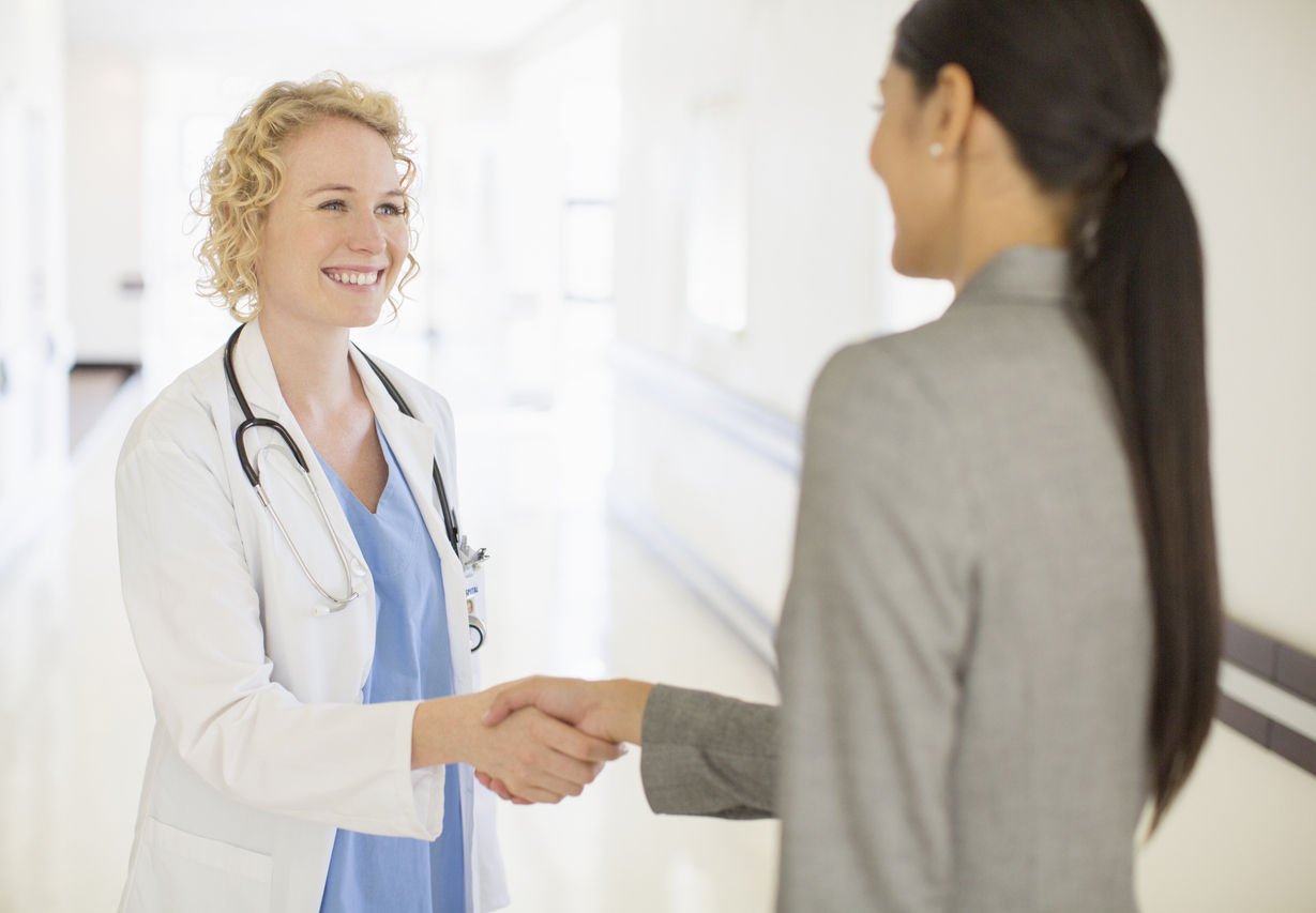 Chief Nursing Informatics Officer Shaking Hands With a Doctor in a Medical Facility.